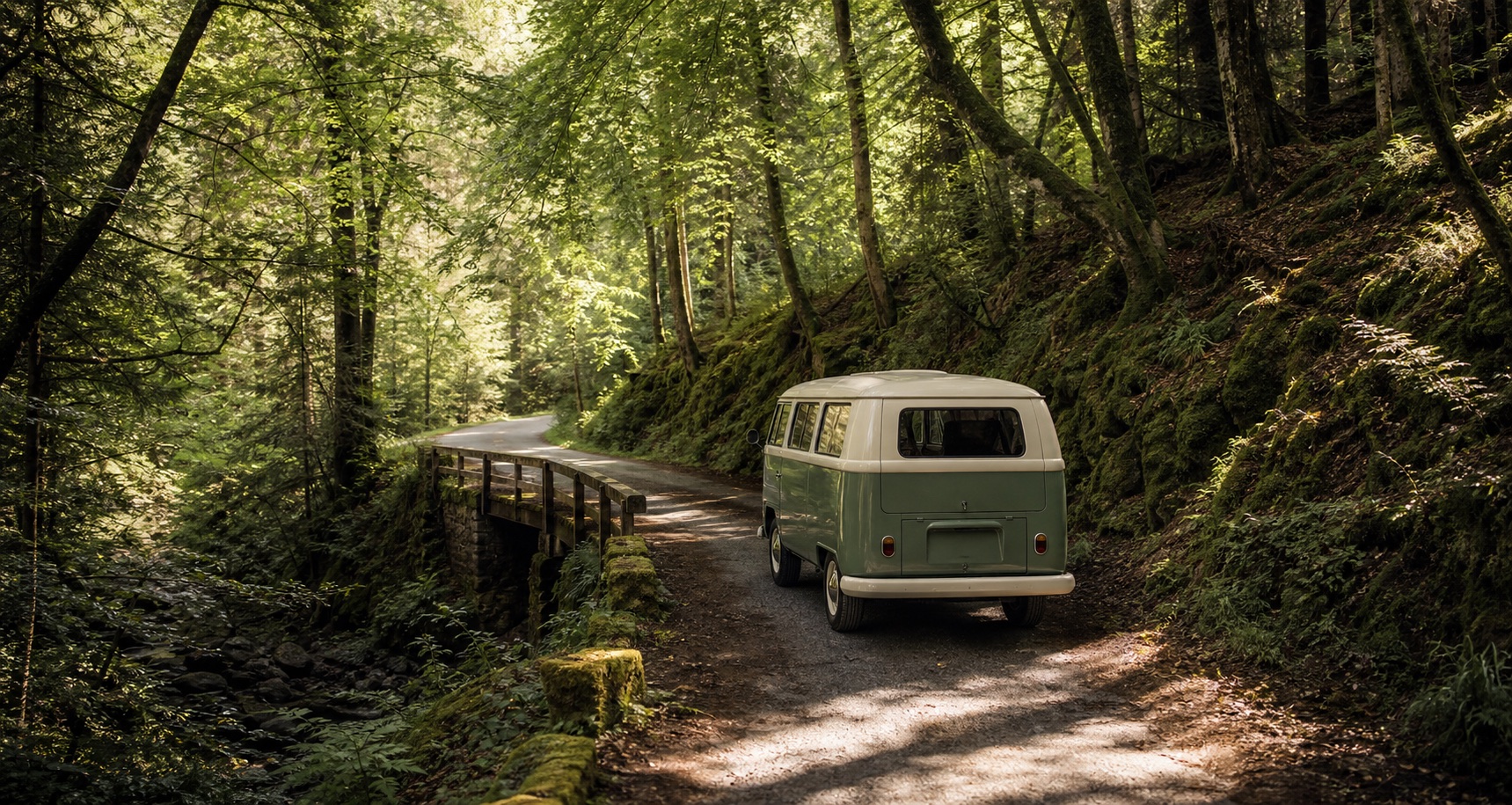 A vintage camper van driving through a forest road.